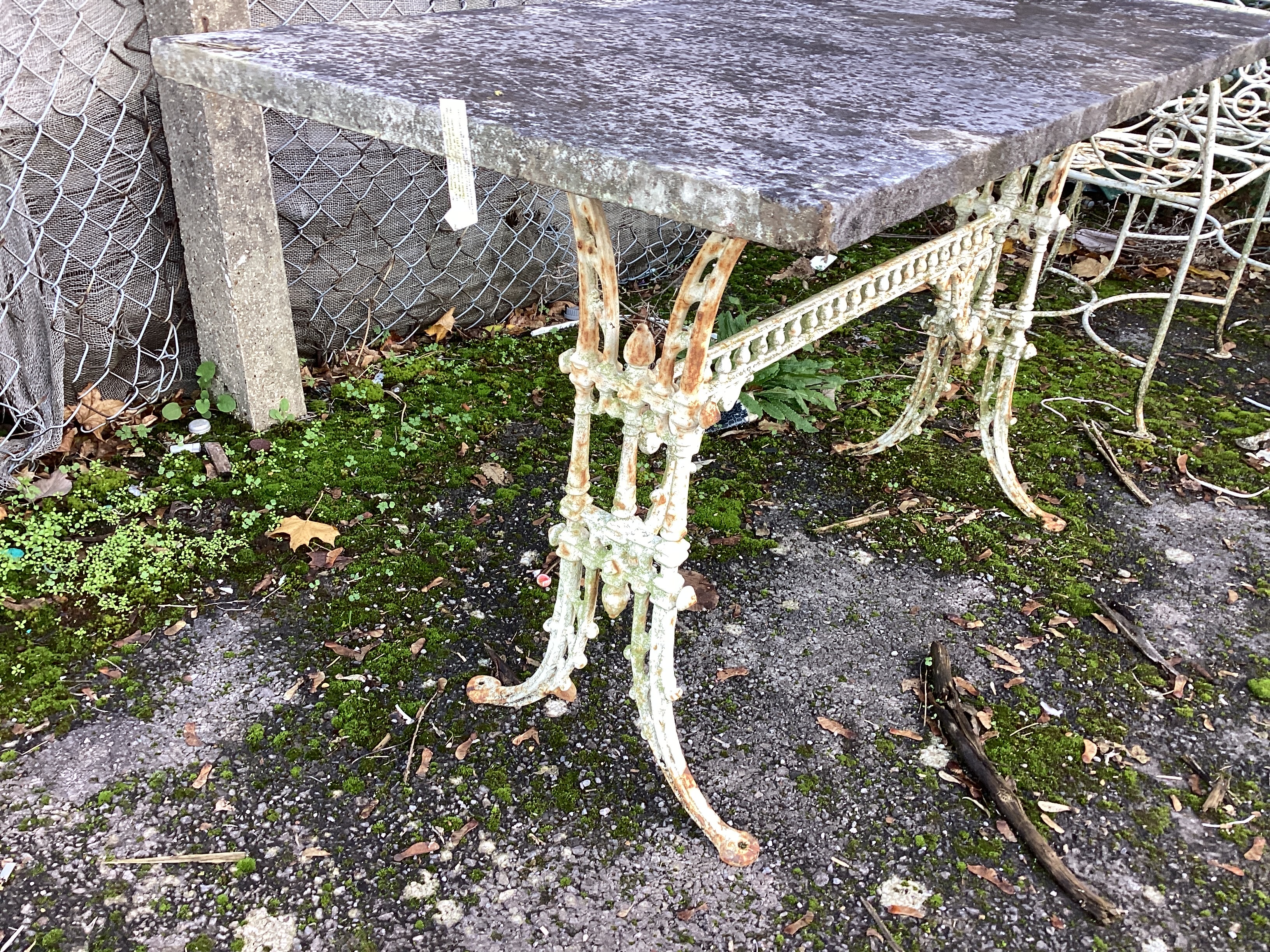 A Victorian cast iron table garden table with weathered marble top, width 139cm, height 71cm